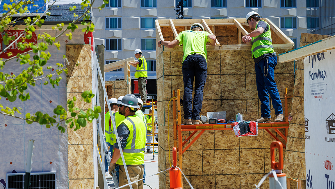 Construction Management students working on sheds for their Vertical Engineering class outside Kiewit Hall. May 9, 2025.
