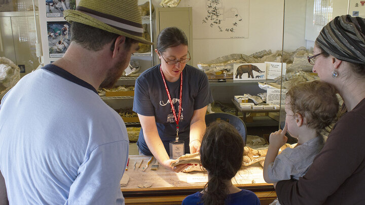 A family learns more about fossils from one of Ashfall Fossil Beds’ summer interns at the park’s Working Visible Lab.