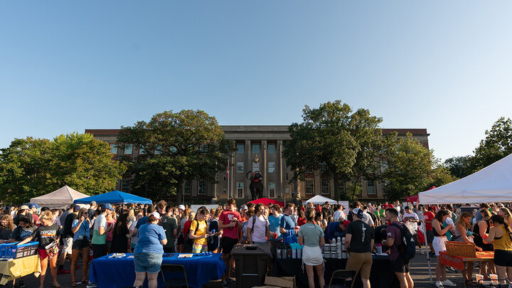 Students walk around East Memorial Stadium Loop during the Big Red Welcome Street Festival.