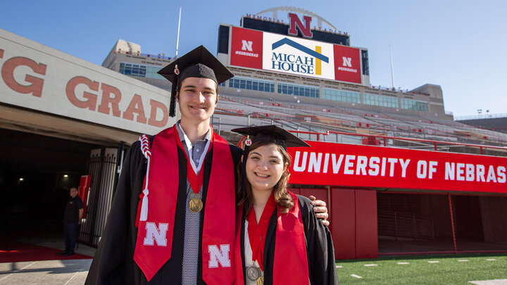 Max Radlicz and Trinity Mozingo standing side-by-side in Memorial Stadium prior to commencement on May 18.
