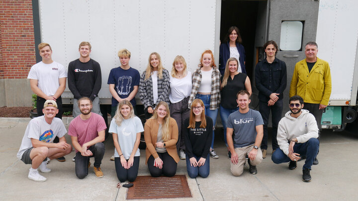 FACT studio students pose in front of their Omaha Mobile Stage