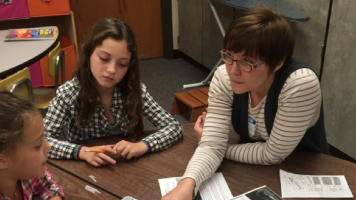 UNL doctoral student and entomologist Erin Ingram works with Evelyn Hamlow Elementary School students Grace Ehlers and Addison Stephens on a project focused on saving honey bees. 