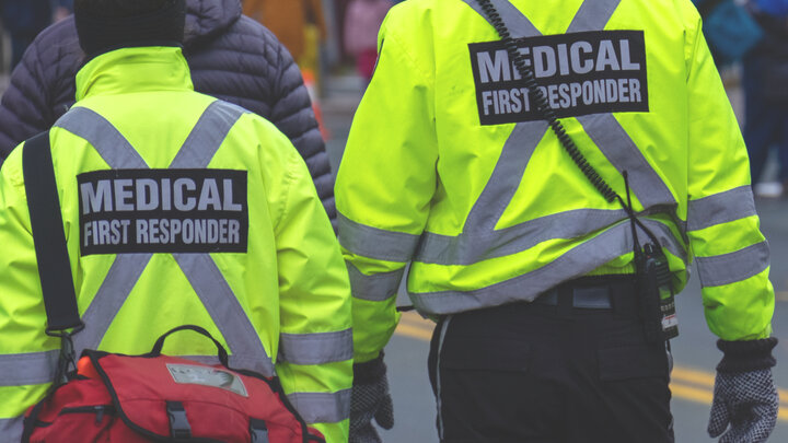 Emergency Medical Technicians approach a scene.